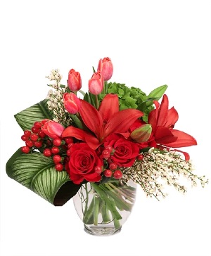 Sophisticated scarlet vase arrangement with red roses, lilies, and tulips